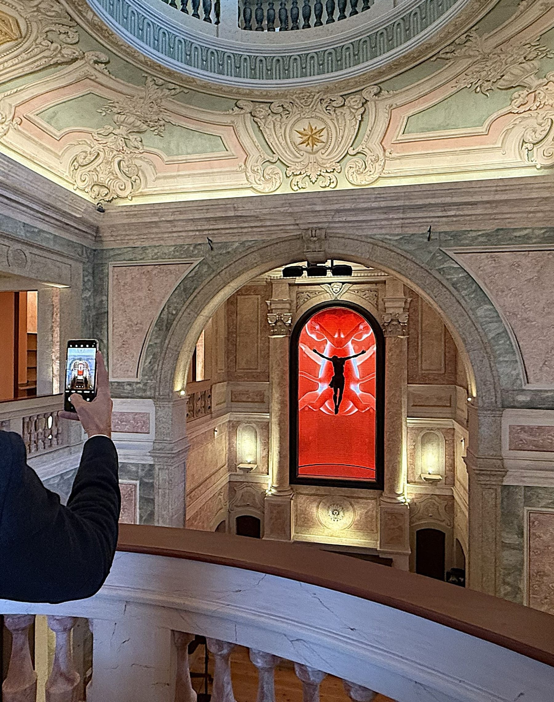 The àcapela bar from the piano nobile, Trinity — the installation by the Spanish artist Carlos Aires — burning red in the chancel arch, and the painted dome above.