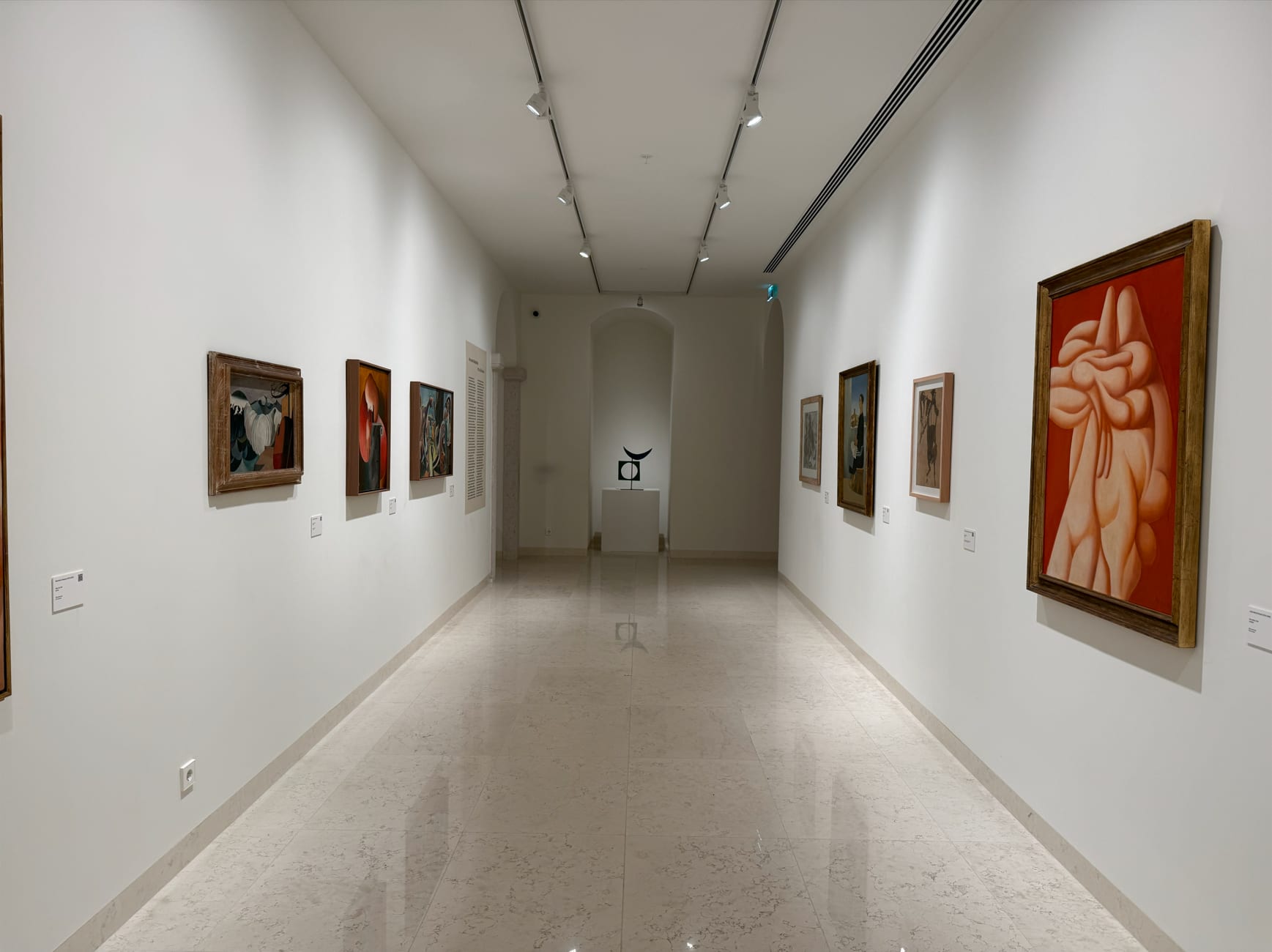 The transition gallery, its track of spotlights answering displays that change.