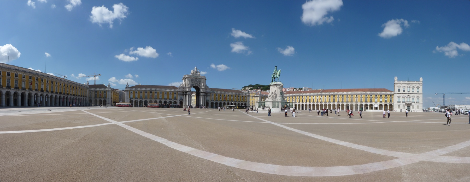 The facades of the Praça do Comércio lit, the arcade running the length of the square.
